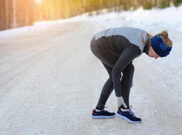 Foto von Joggerin mit Schmerzen an der Achillessehne